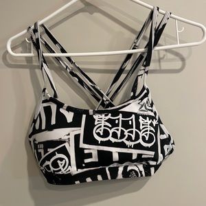 Reebok small graffiti print sports bra with removable padding